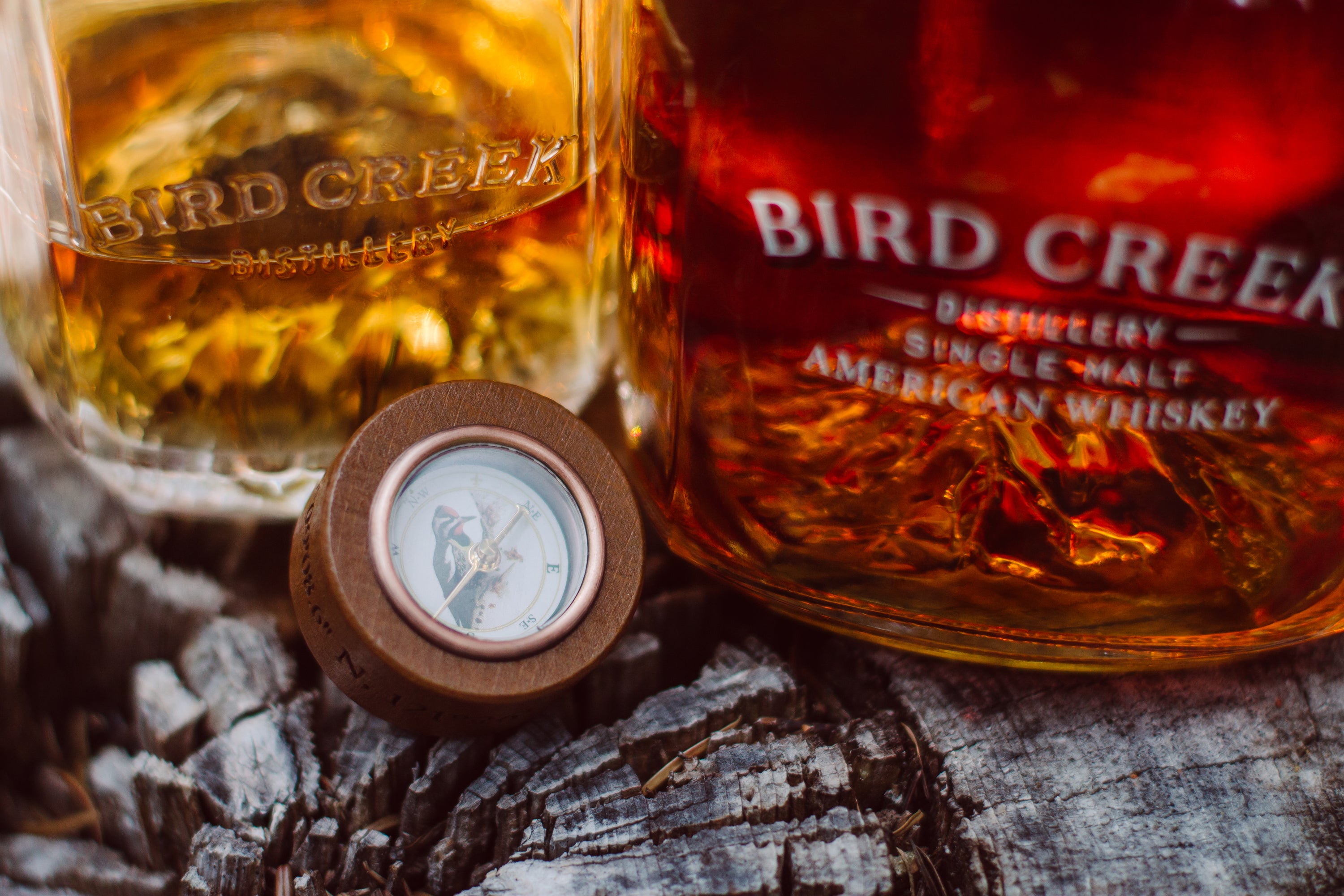 Bird Creek Whiskey - Bottle cap close up, tumbler and bottle detail
